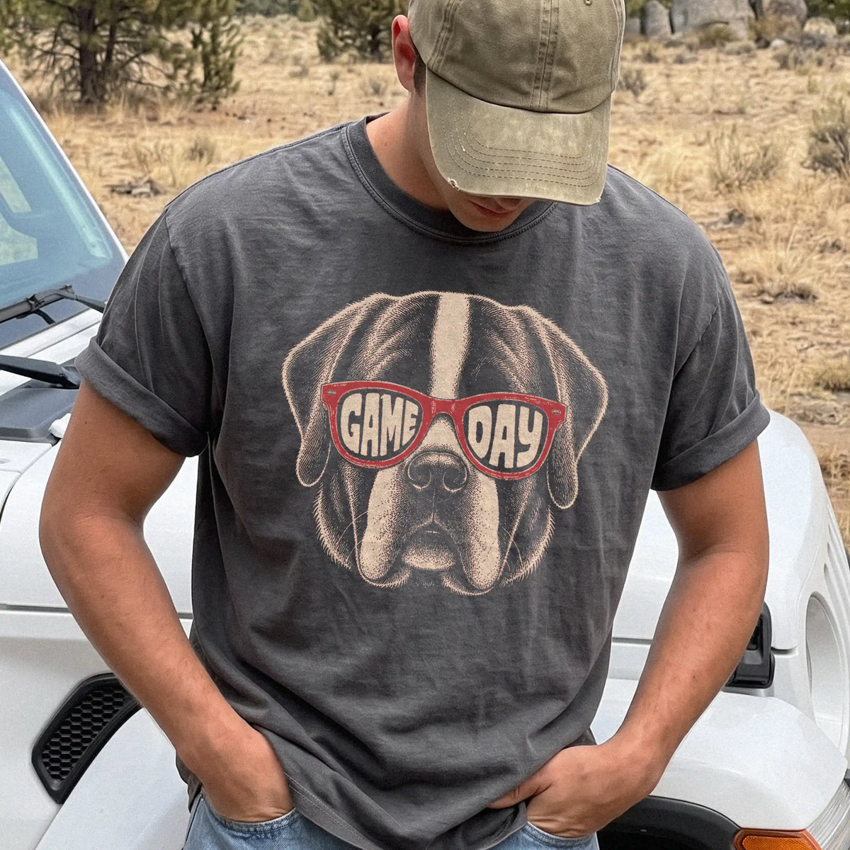 Model wearing a Pepper Comfort Colors® T-shirt with saint bernard wearing red game day sunglasses