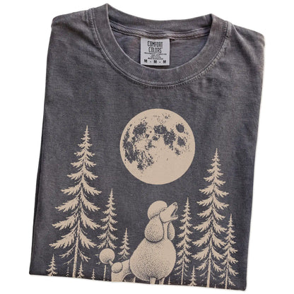 Folded Pepper Comfort Colors® T-shirt showing a Standard Poodle howling beneath the moon and pine trees