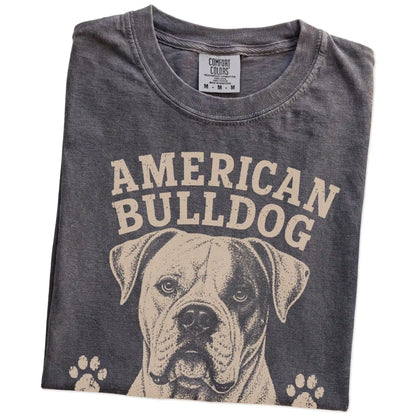 Folded Pepper Comfort Colors® T-shirt showing American Bulldog design with “Strong Opinions, Stronger Heart” lettering