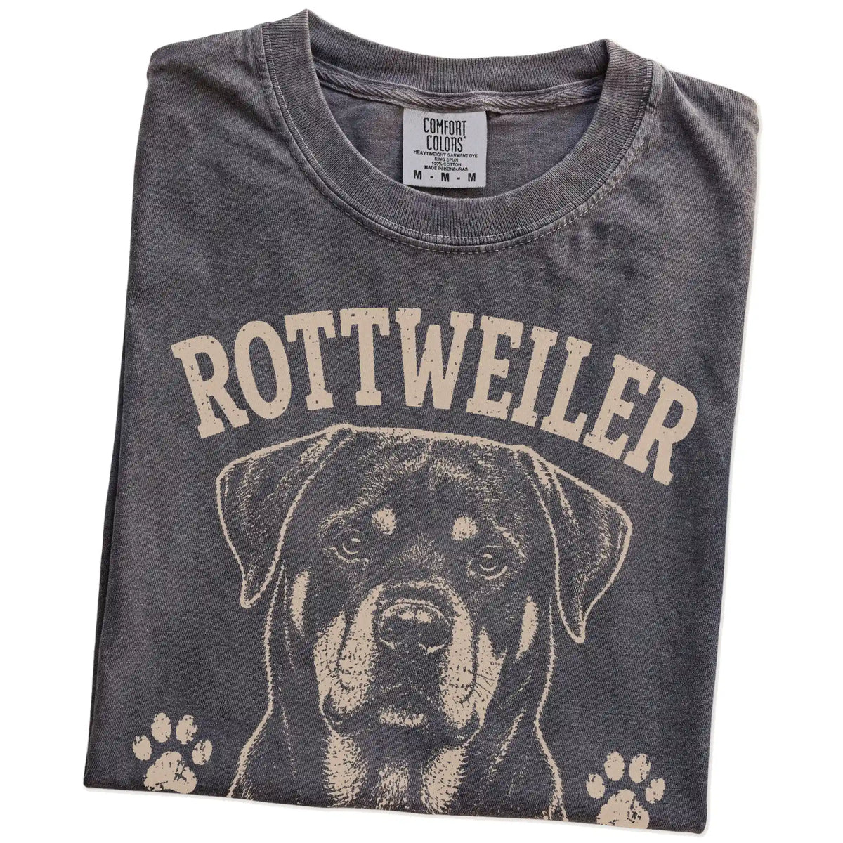 Folded Pepper Comfort Colors® T-shirt showing Rottweiler design with “Strong, Silent & Secretly Sweet” lettering