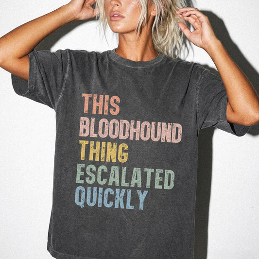 Model wearing a Pepper Comfort Colors® T-shirt with retro “This Bloodhound Thing Escalated Quickly” lettering