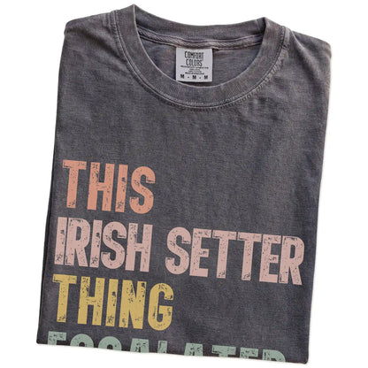 Folded Pepper Comfort Colors® T-shirt showing retro “This Irish Setter Thing Escalated Quickly” lettering