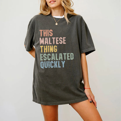 Model wearing a Pepper Comfort Colors® T-shirt with retro “This Maltese Thing Escalated Quickly” lettering