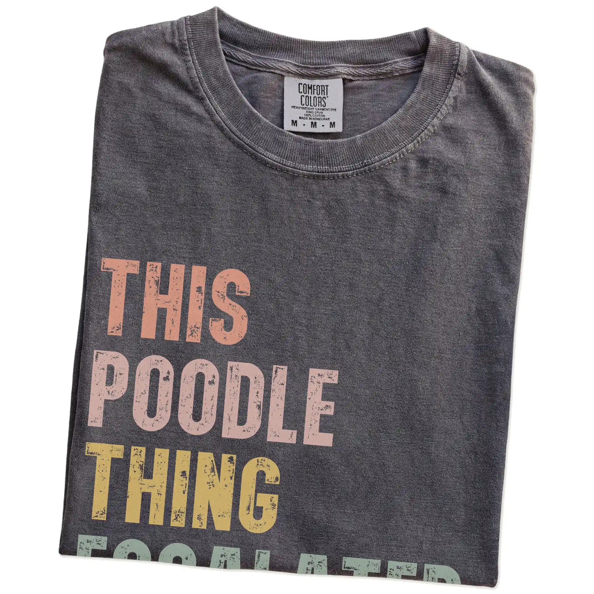 Folded Pepper Comfort Colors® T-shirt showing retro “This Poodle Thing Escalated Quickly” lettering