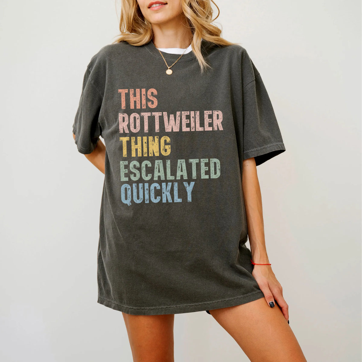 Model wearing a Pepper Comfort Colors® T-shirt with retro “This Rottweiler Thing Escalated Quickly” lettering