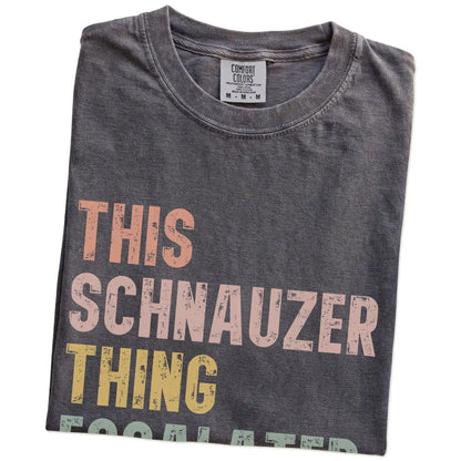 Folded Pepper Comfort Colors® T-shirt showing retro “This Schnauzer Thing Escalated Quickly” lettering