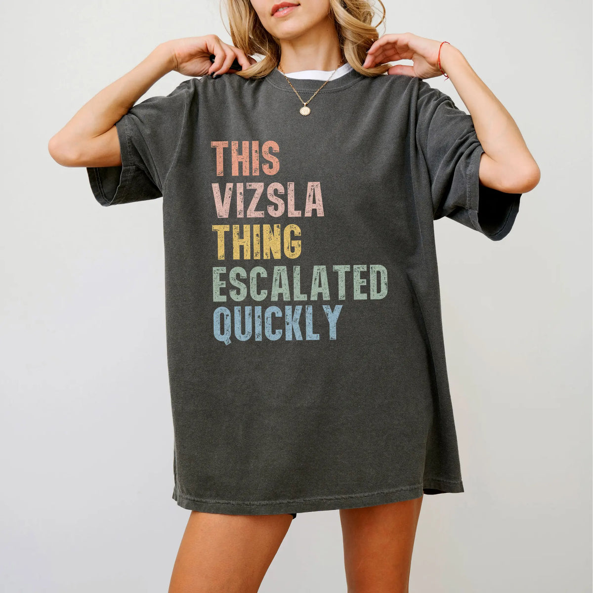 Model wearing a Pepper Comfort Colors® T-shirt with retro “This Vizsla Thing Escalated Quickly” lettering