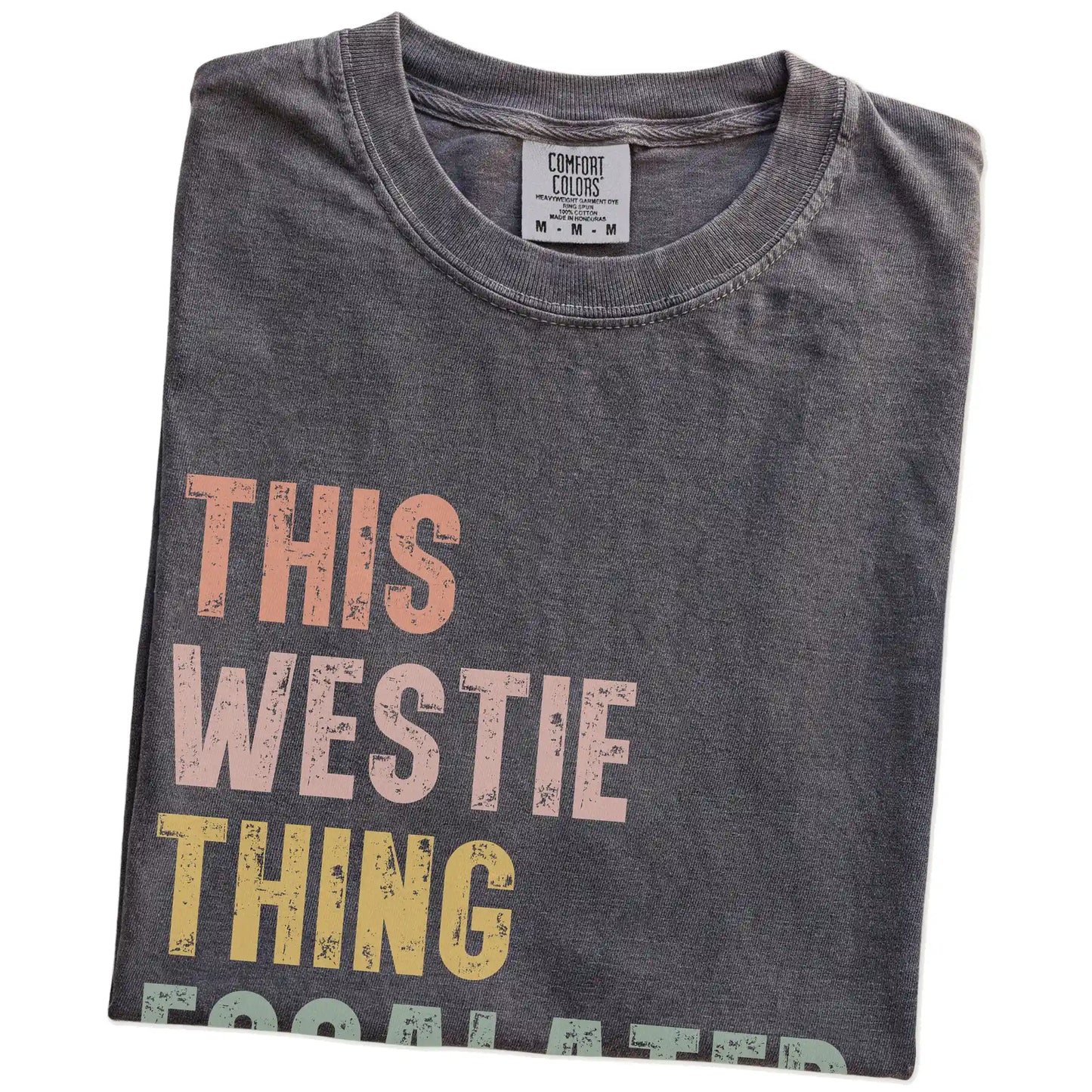 Folded Pepper Comfort Colors® T-shirt showing retro “This Westie Thing Escalated Quickly” lettering