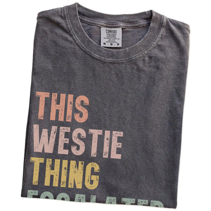 Folded Pepper Comfort Colors® T-shirt showing retro “This Westie Thing Escalated Quickly” lettering