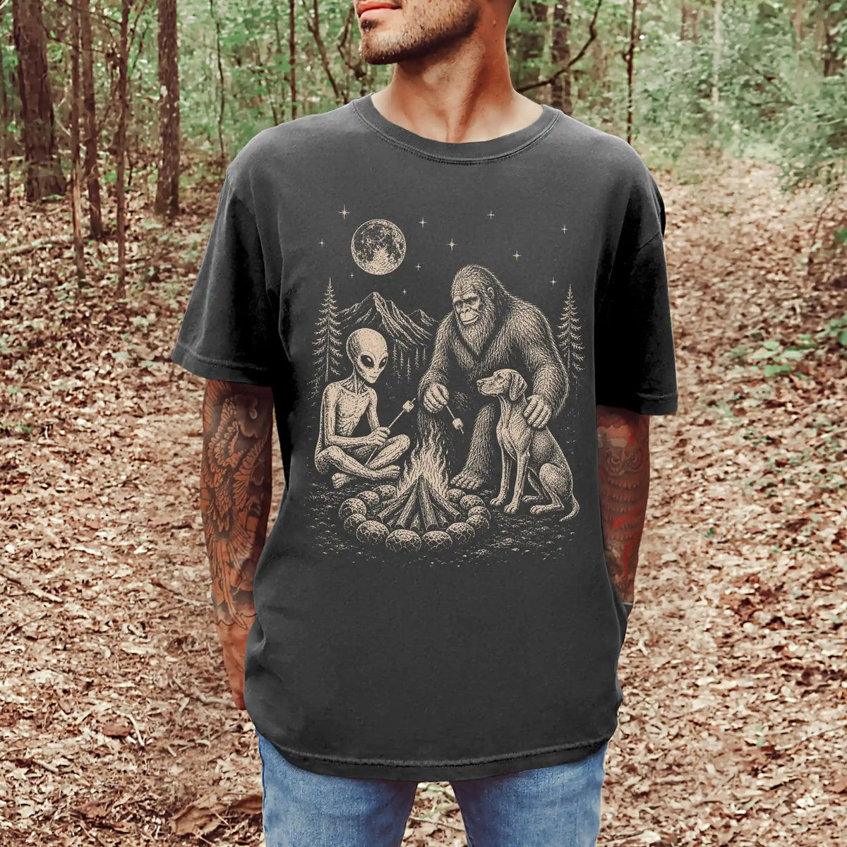Model wearing a Pepper Comfort Colors® T-shirt showing Vizsla camping with Bigfoot and an alien