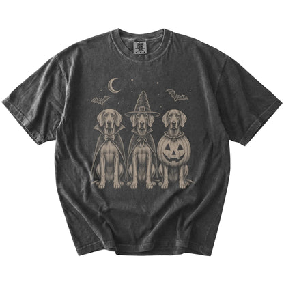 Three Weimaraner dogs dressed for Halloween beneath bats and a crescent moon on a Pepper Comfort Colors® T-shirt