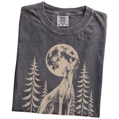 Folded Pepper Comfort Colors® T-shirt showing a Weimaraner howling beneath the moon and pine trees