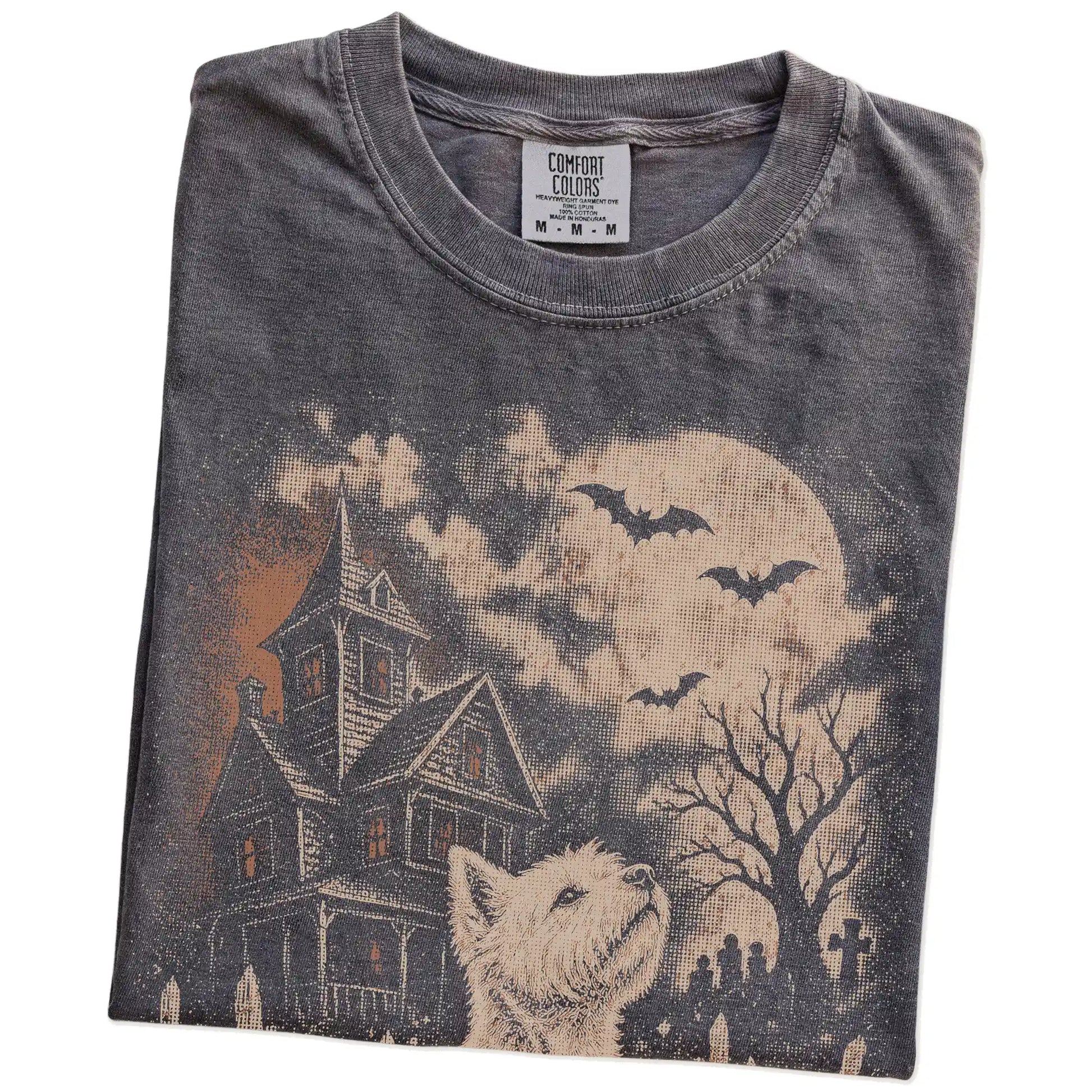 Folded Pepper Comfort Colors® T-shirt showing Westie in a vintage haunted-house scene