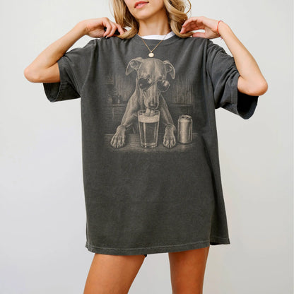 Model wearing a Pepper Comfort Colors® t-shirt with Whippet sneaking a drink from a pint