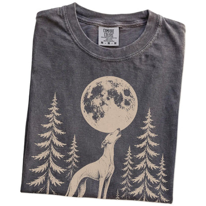 Folded Pepper Comfort Colors® T-shirt showing a Whippet howling beneath the moon and pine trees