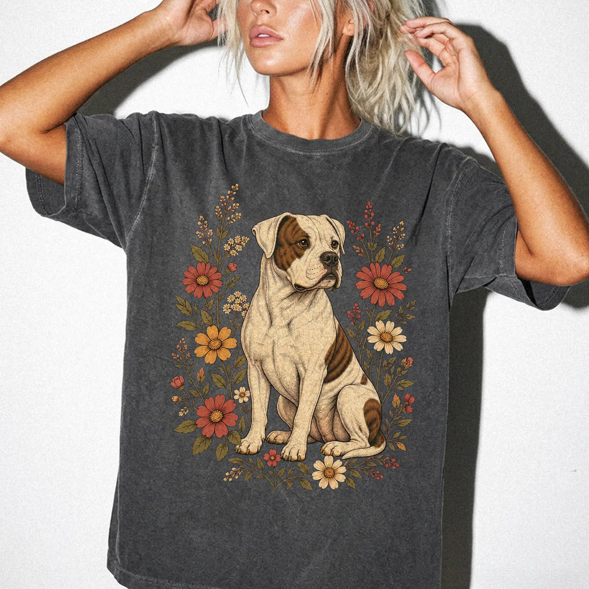 Model wearing a Pepper Comfort Colors® T-shirt showing American Bulldog portrait surrounded by wildflowers beneath the moon