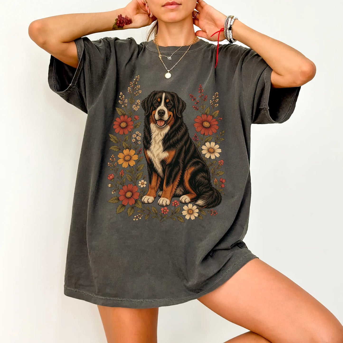 Model wearing a Pepper Comfort Colors® T-shirt showing Bernese Mountain Dog portrait surrounded by wildflowers beneath the mo