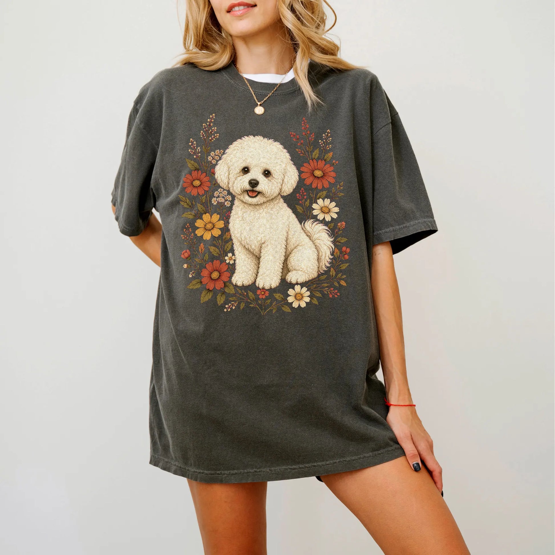 Model wearing a Pepper Comfort Colors® T-shirt showing Bichon Frise portrait surrounded by wildflowers beneath the moon