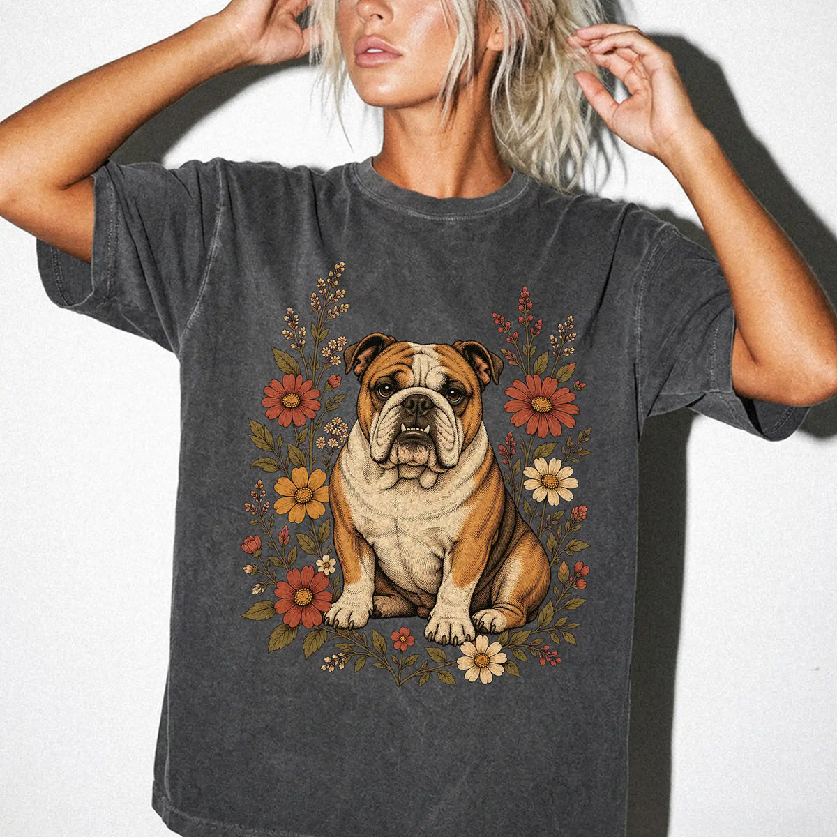 Model wearing a Pepper Comfort Colors® T-shirt showing Bulldog portrait surrounded by wildflowers beneath the moon