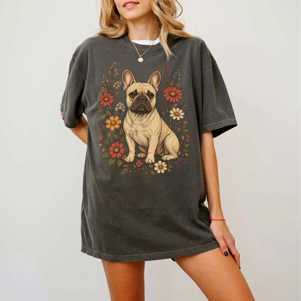 Model wearing a Pepper Comfort Colors® T-shirt showing French Bulldog portrait surrounded by wildflowers beneath the moon
