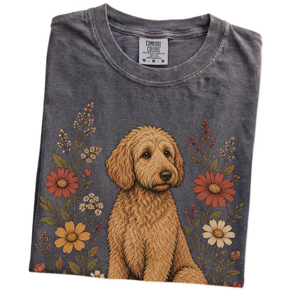 Folded Pepper Comfort Colors® T-shirt showing Goldendoodle portrait surrounded by wildflowers beneath the moon