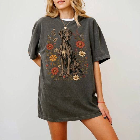 Model wearing a Pepper Comfort Colors® T-shirt showing Great Dane portrait surrounded by wildflowers beneath the moon