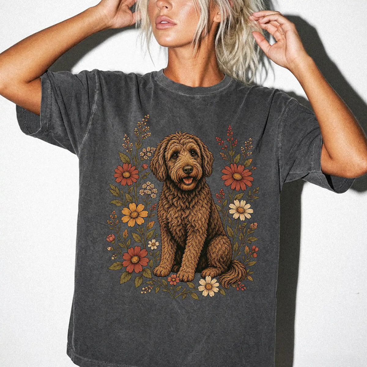Model wearing a Pepper Comfort Colors® T-shirt showing Labradoodle portrait surrounded by wildflowers beneath the moon