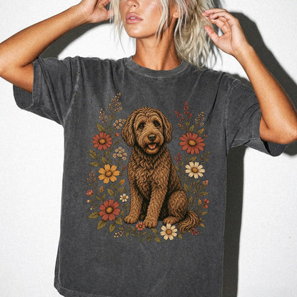 Model wearing a Pepper Comfort Colors® T-shirt showing Labradoodle portrait surrounded by wildflowers beneath the moon