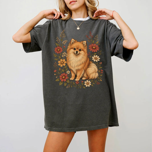 Model wearing a Pepper Comfort Colors® T-shirt showing Pomeranian portrait surrounded by wildflowers beneath the moon