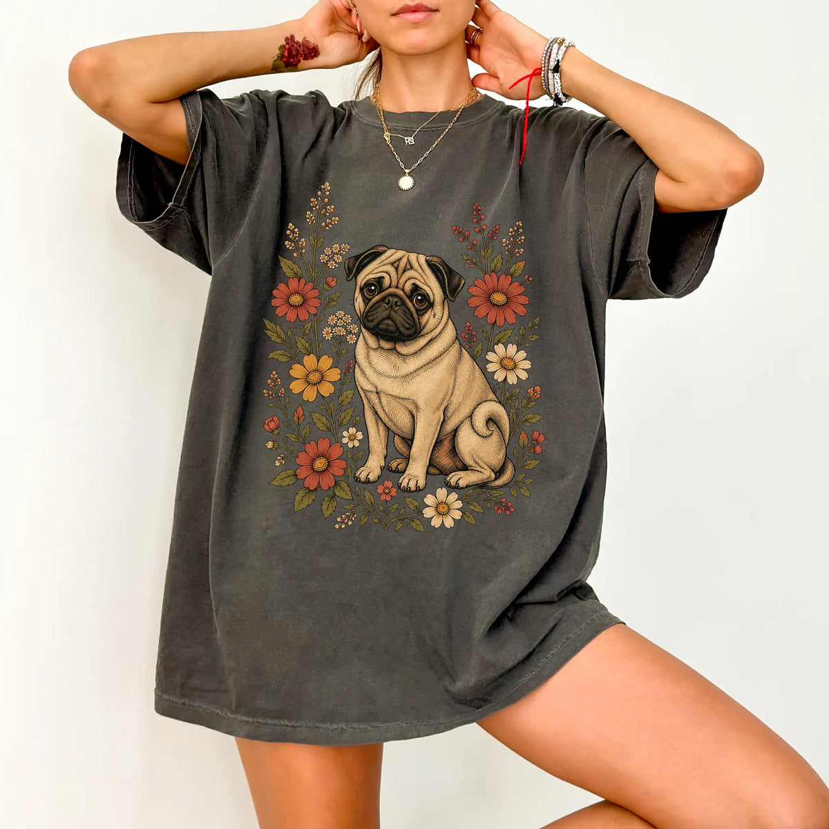 Model wearing a Pepper Comfort Colors® T-shirt showing Pug portrait surrounded by wildflowers beneath the moon