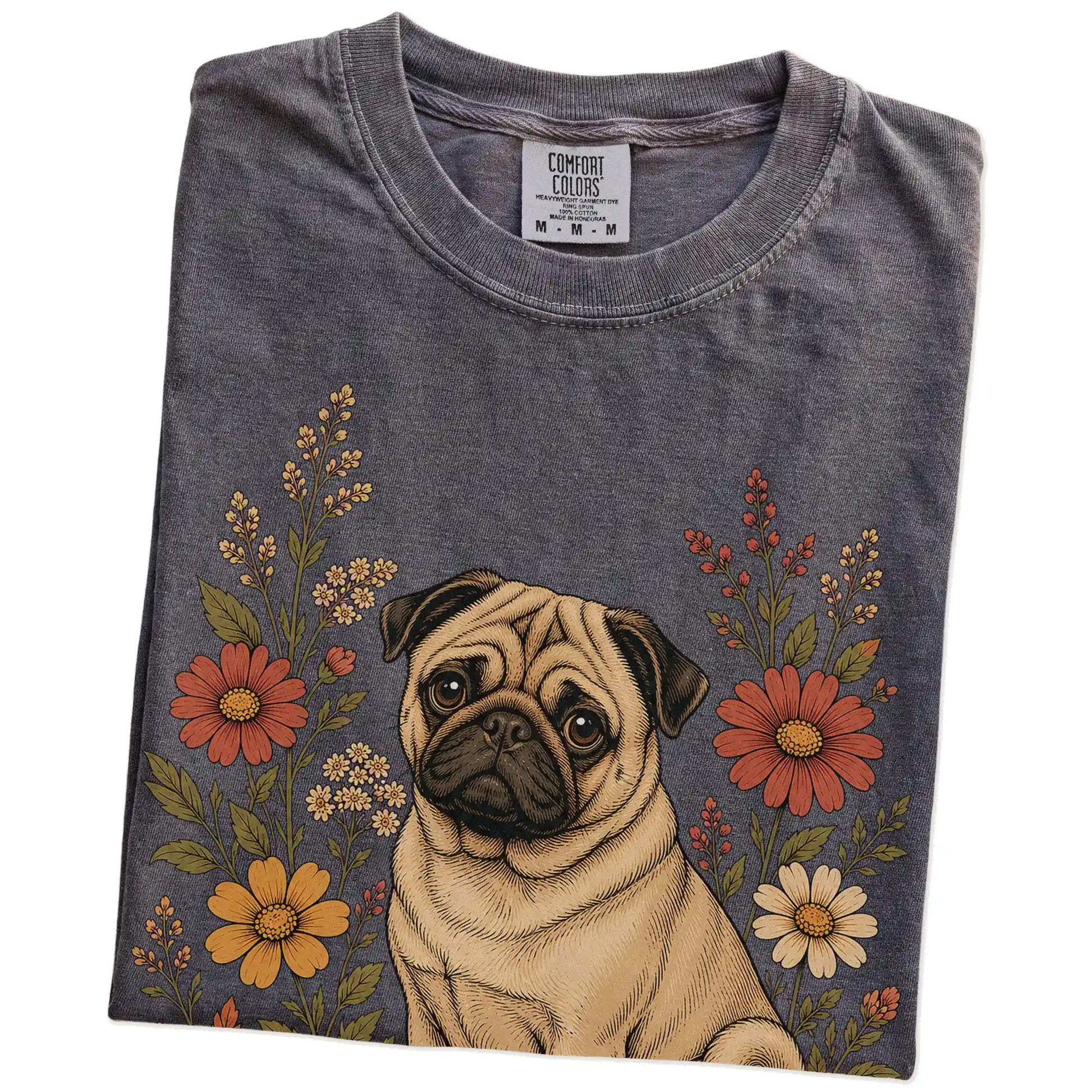 Folded Pepper Comfort Colors® T-shirt showing Pug portrait surrounded by wildflowers beneath the moon