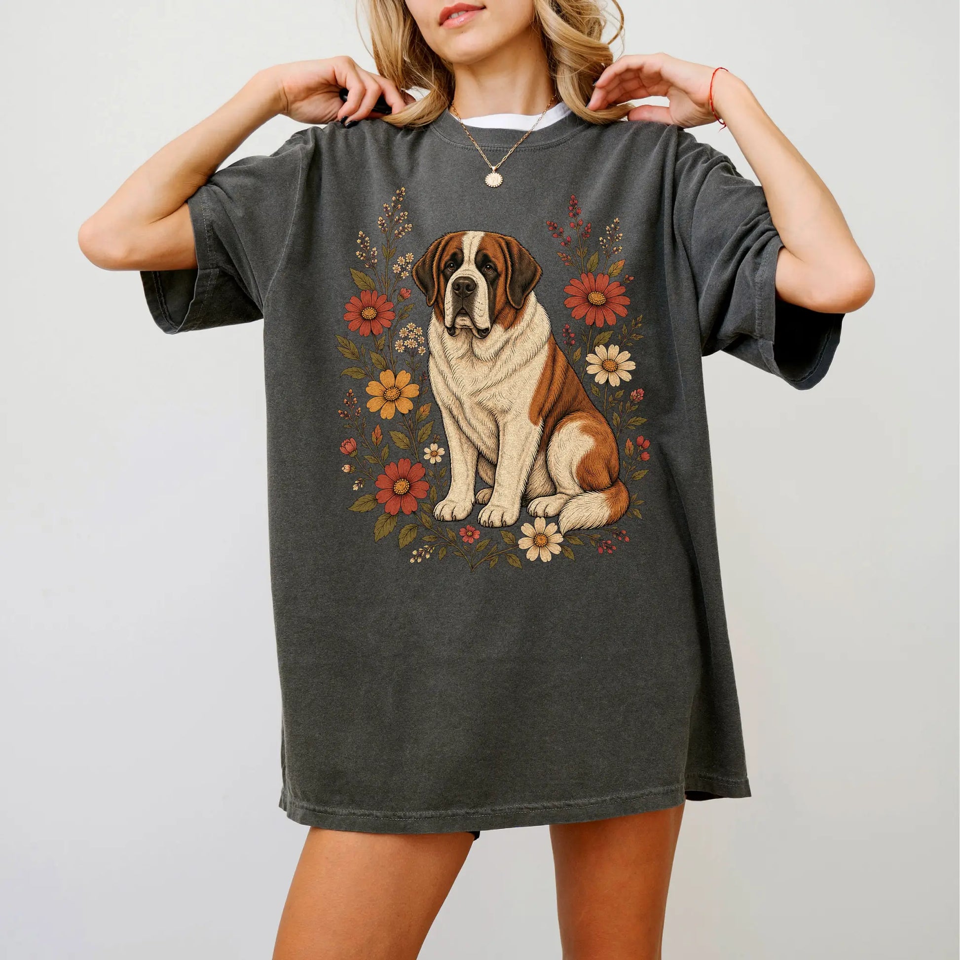 Model wearing a Pepper Comfort Colors® T-shirt showing Saint Bernard portrait surrounded by wildflowers beneath the moon