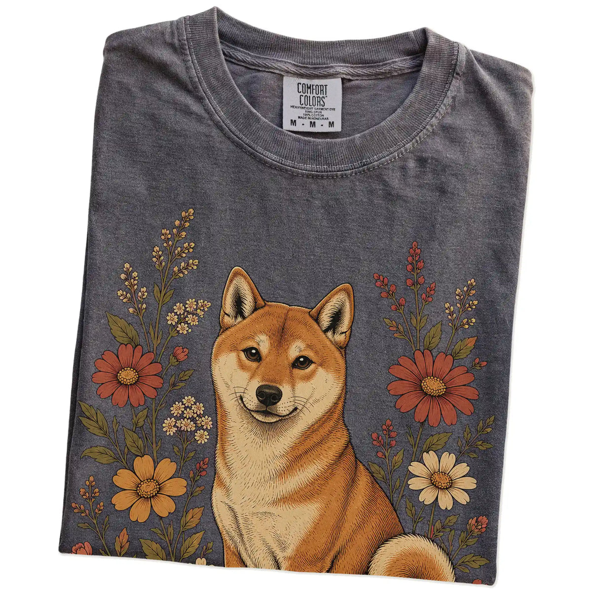 Folded Pepper Comfort Colors® T-shirt showing Shiba Inu portrait surrounded by wildflowers beneath the moon