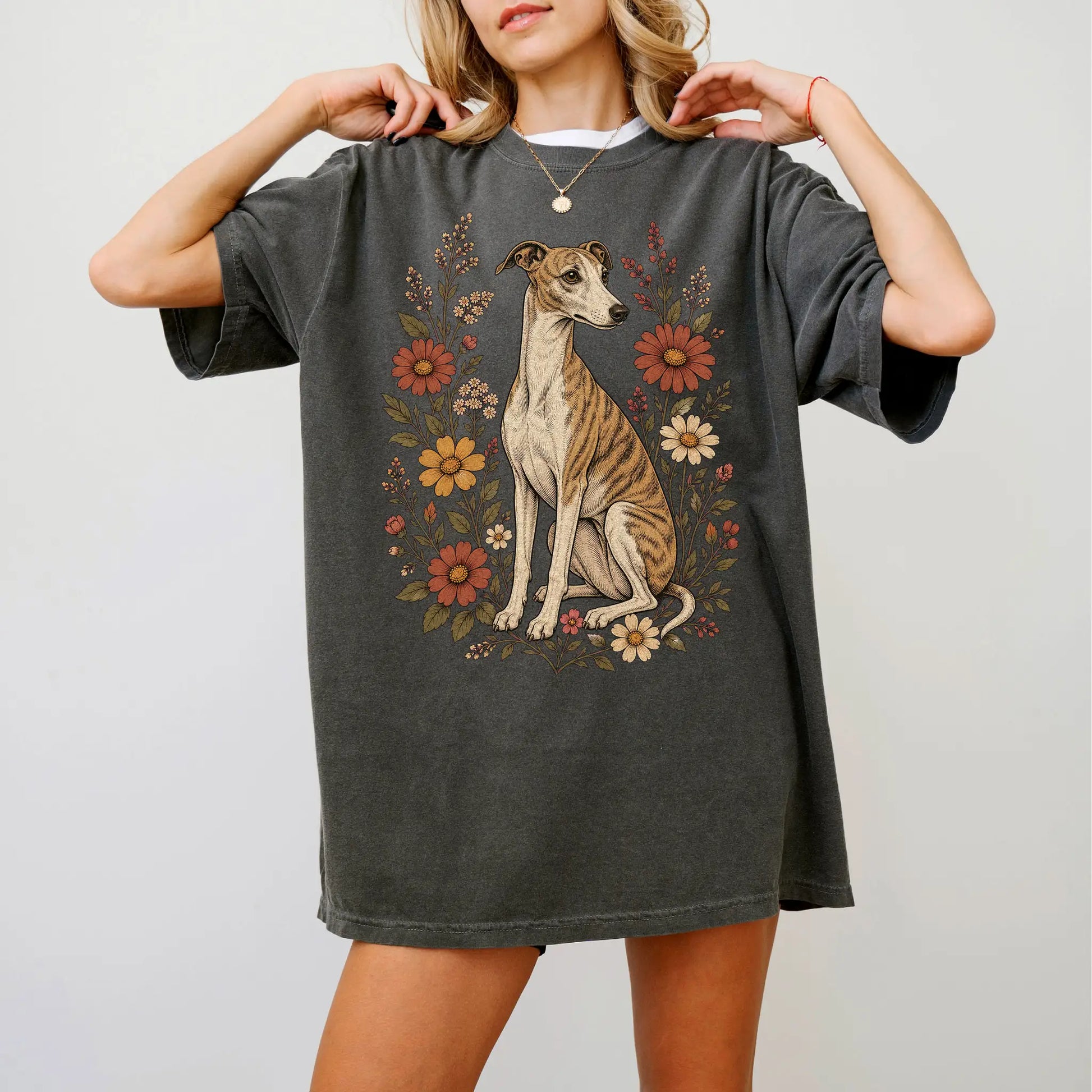 Model wearing a Pepper Comfort Colors® T-shirt showing Whippet portrait surrounded by wildflowers beneath the moon