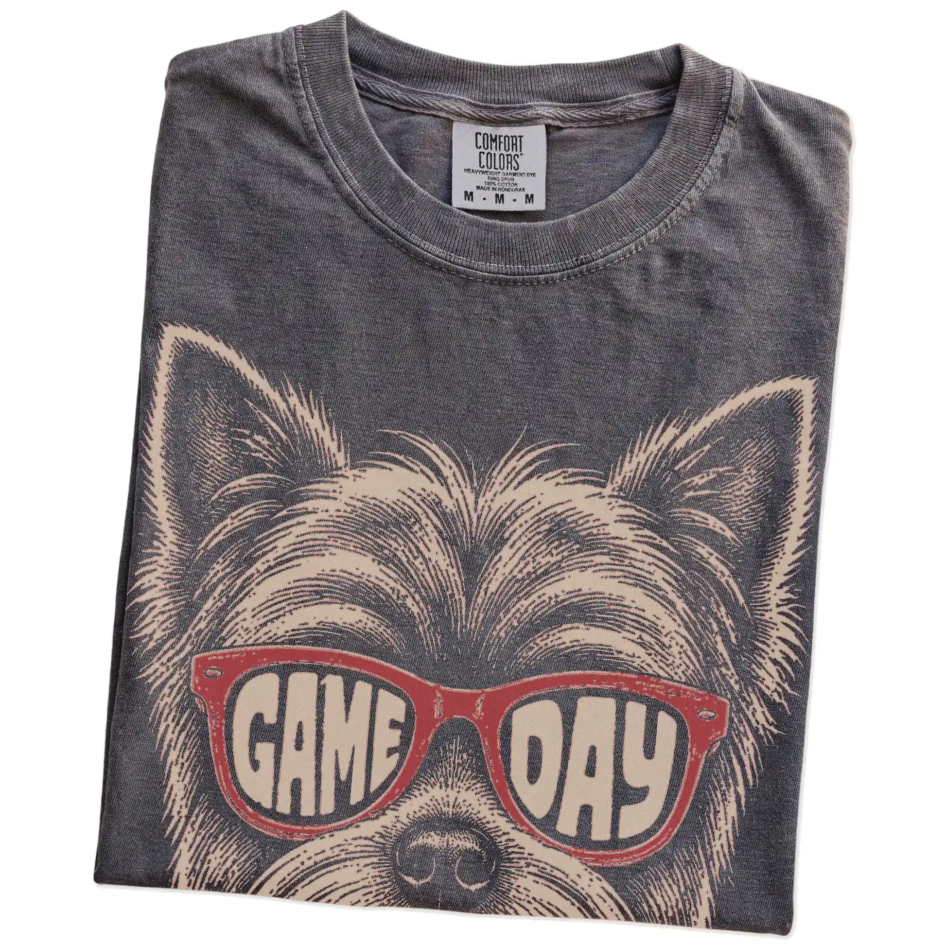 Folded Pepper Comfort Colors® T-shirt showing yorkie wearing red game day sunglasses