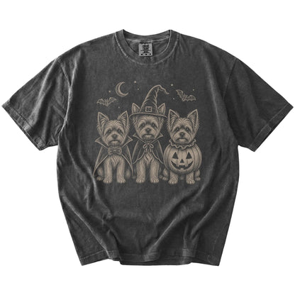 Three Yorkie dogs dressed for Halloween beneath bats and a crescent moon on a Pepper Comfort Colors® T-shirt