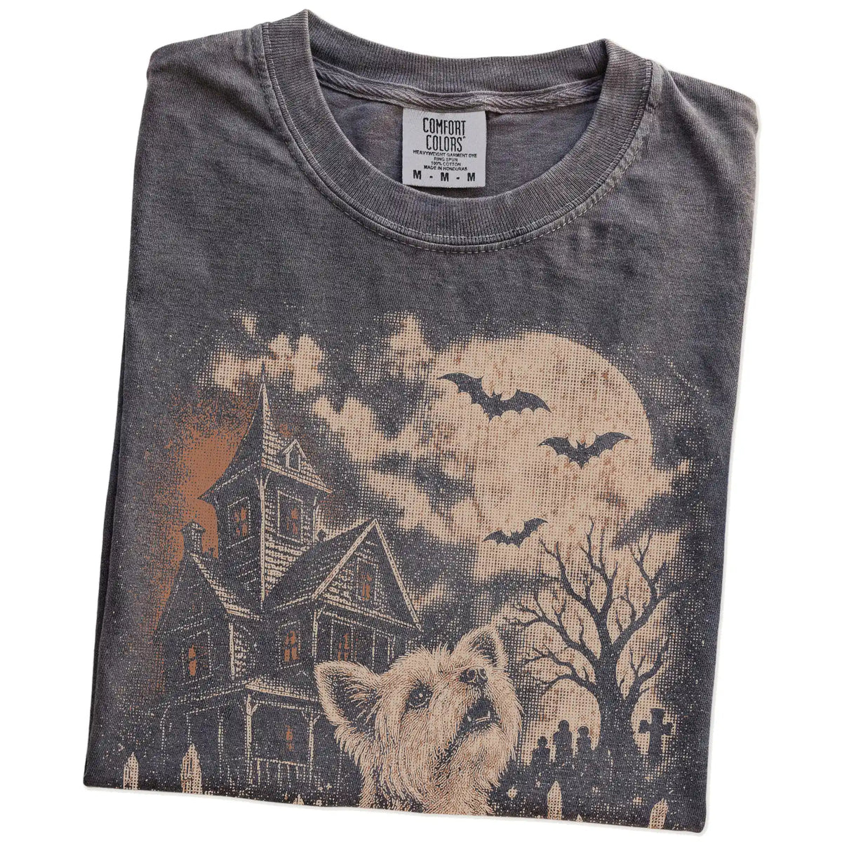 Folded Pepper Comfort Colors® T-shirt showing Yorkie in a vintage haunted-house scene