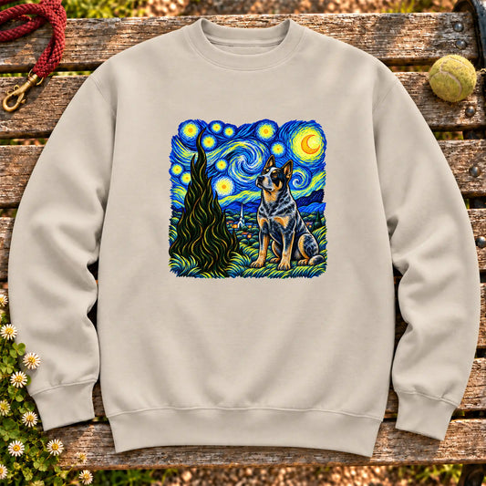 Colorful Blue Heeler beneath a swirling starry night sky on a Sand sweatshirt