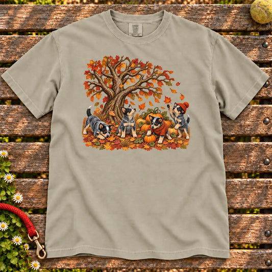 Four Blue Heeler puppies with pumpkins beneath an autumn tree on a Sandstone garment-dyed T-shirt