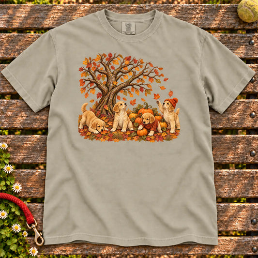 Four Golden Retriever puppies with pumpkins beneath an autumn tree on a Sandstone garment-dyed T-shirt