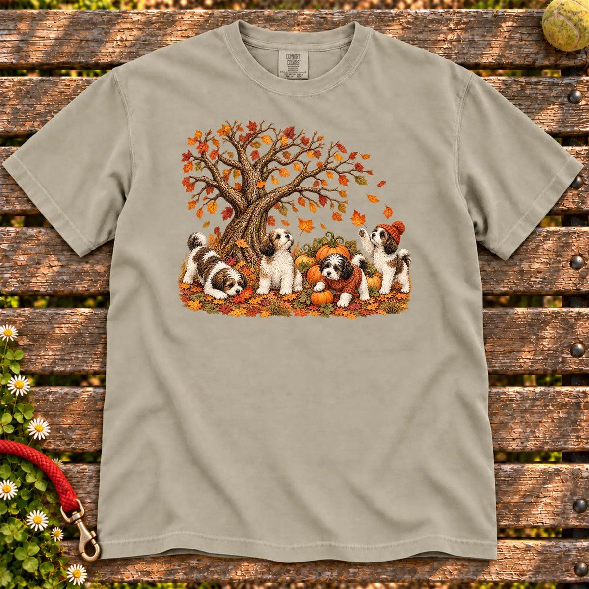 Four Havanese puppies with pumpkins beneath an autumn tree on a Sandstone garment-dyed T-shirt