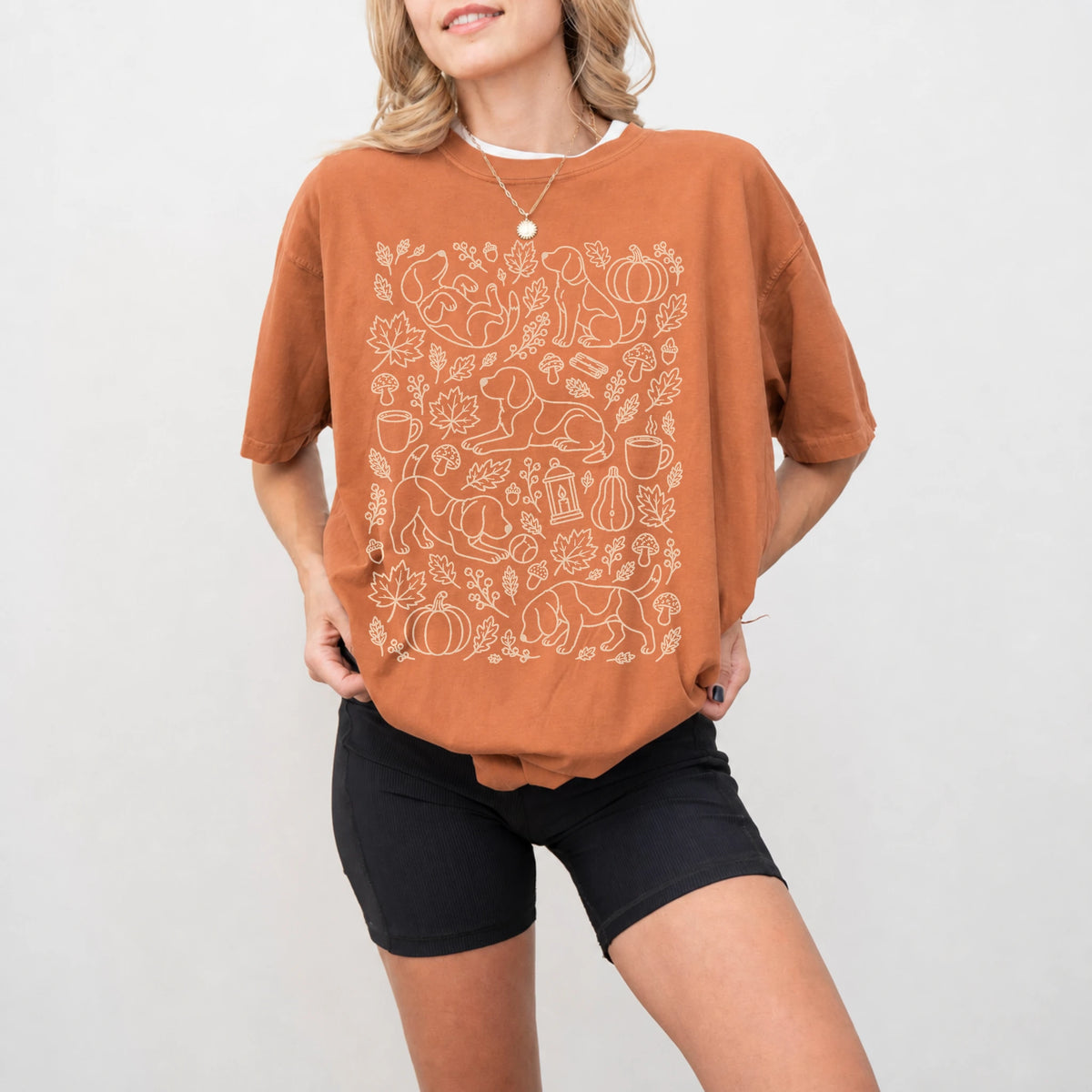 Model wearing a Yam Comfort Colors® T-shirt with Beagle dogs with pumpkins, leaves, acorns, and woodland details