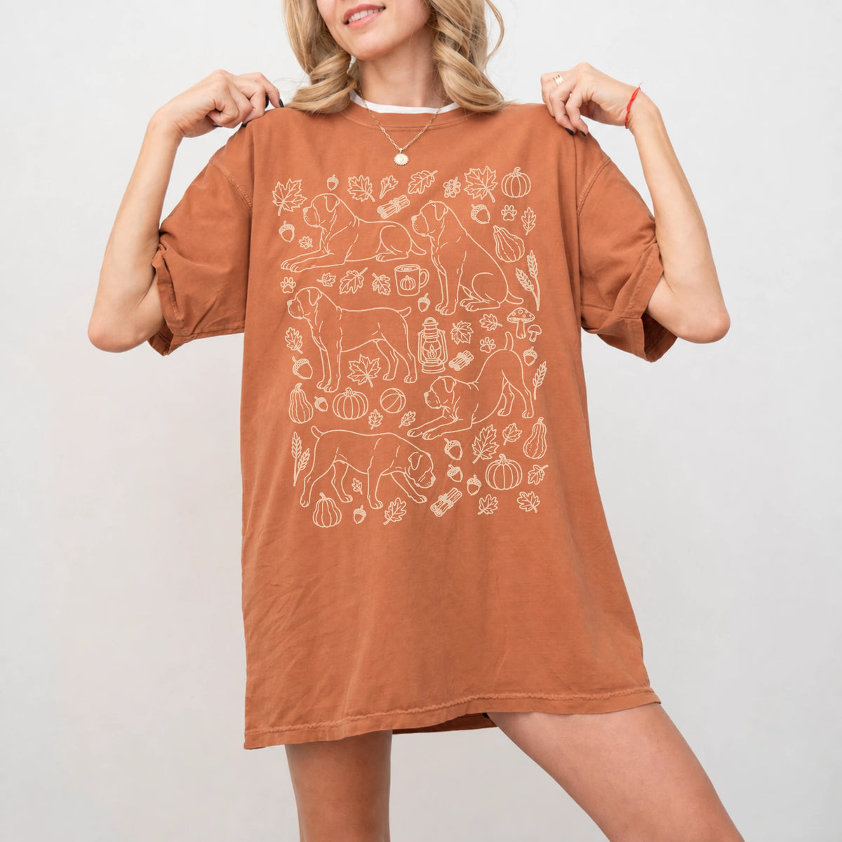 Model wearing a Yam Comfort Colors® T-shirt with Cane Corso dogs with pumpkins, leaves, acorns, and woodland details