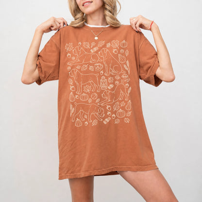Model wearing a Yam Comfort Colors® T-shirt with Cane Corso dogs with pumpkins, leaves, acorns, and woodland details