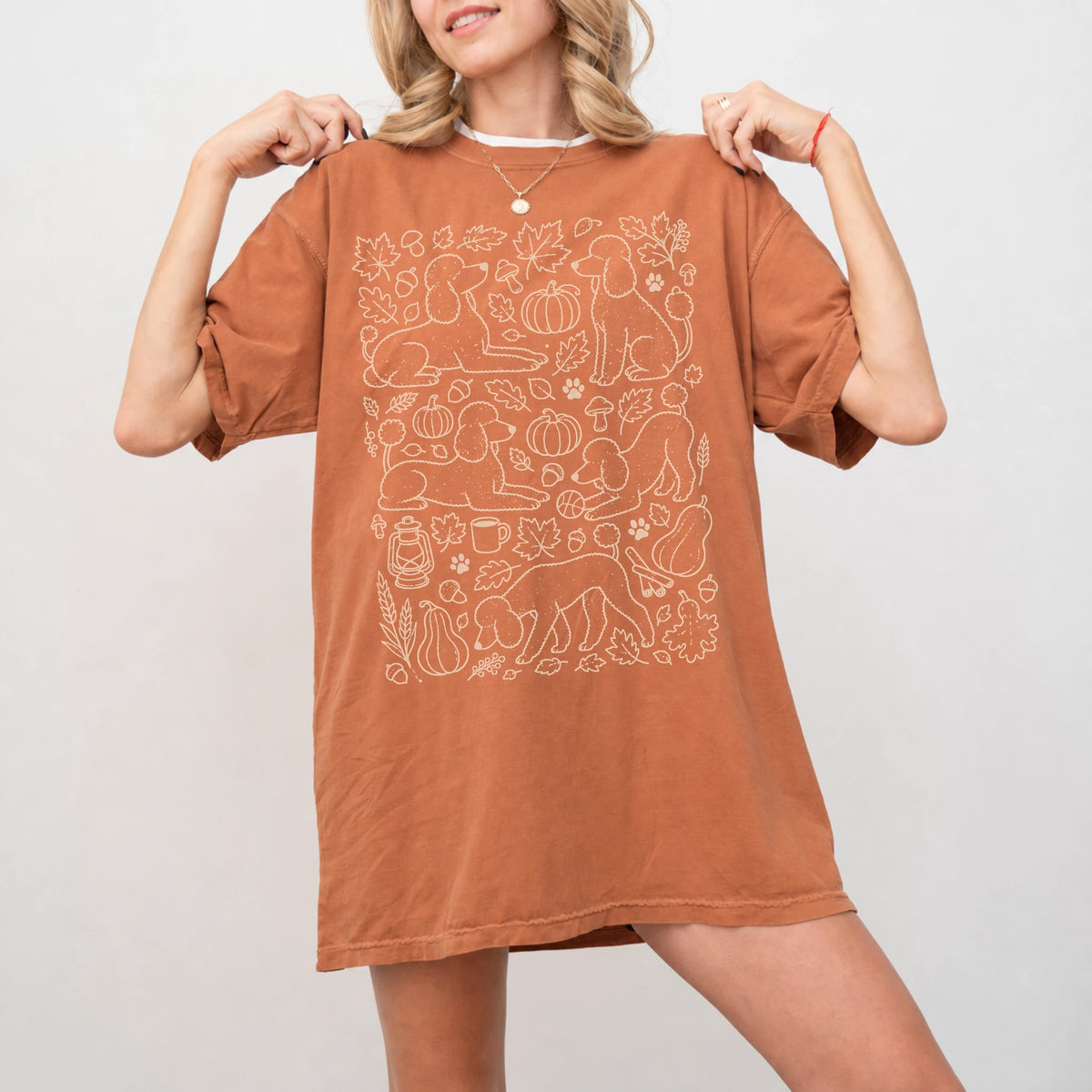 Model wearing a Yam Comfort Colors® T-shirt with Poodle dogs with pumpkins, leaves, acorns, and woodland details