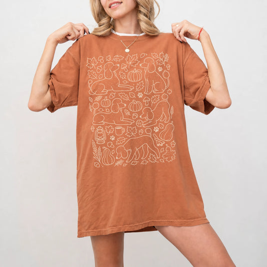 Model wearing a Yam Comfort Colors® T-shirt with Poodle dogs with pumpkins, leaves, acorns, and woodland details