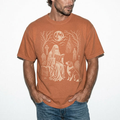 Model wearing a Yam Comfort Colors® T-shirt showing Australian Shepherd beside a reading ghost in a moonlit graveyard