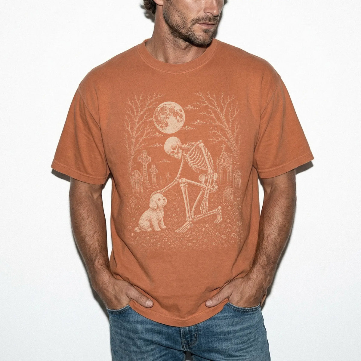 Model wearing a Yam Comfort Colors® T-shirt showing Bichon Frise sharing a quiet cemetery moment with a friendly skeleton