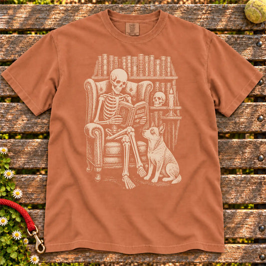 Skeleton reading in a library beside a Blue Heeler on a Yam Comfort Colors® T-shirt