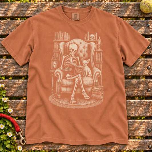 Skeleton reading in a library beside a Chihuahua on a Yam Comfort Colors® T-shirt